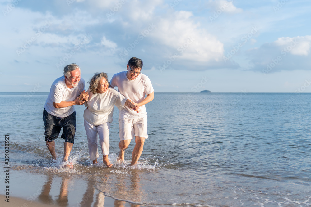 Family On Summer Beach Vacation, Father and mather running with son, Concept for .caring for the elderly, Caregiving to older persons and relations of the family to support elderly state Family On Summer Beach Vacation, Father and mather running with son, Concept for .caring for the elderly, Caregiving to older persons and relations of the family to support elderly state