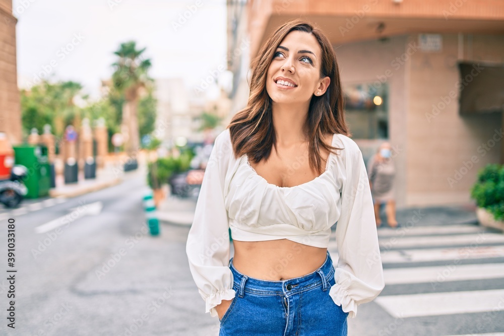Young hispanic woman smiling happy walking at the city. Young hispanic woman smiling happy walking at the city.