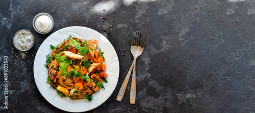 Grilled vegetables and chicken breast salad. Chicken breast, salad, mushrooms, tomatoes, orange. Top view. Free space for text. Dark background. Copy space