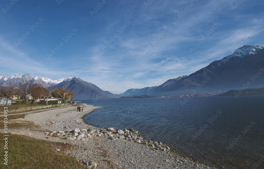 empty beach with great panorama in a cold winter day on the lake and mountains.Como Lake,Lombardy,Italian Lakes,Italy