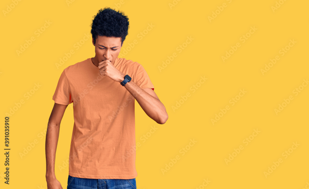 Young african american man wearing casual clothes feeling unwell and coughing as symptom for cold or bronchitis. health care concept. Young african american man wearing casual clothes feeling unwell and coughing as symptom for cold or bronchitis. health care concept.