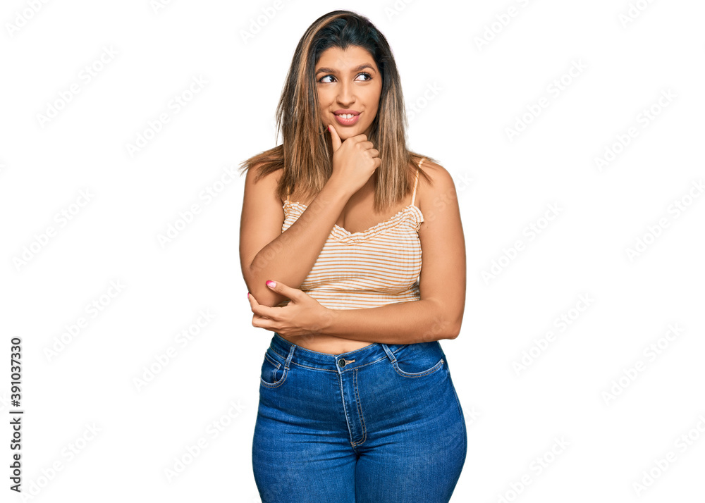 Beautiful brunette woman wearing casual clothes with hand on chin thinking about question, pensive expression. smiling with thoughtful face. doubt concept. Beautiful brunette woman wearing casual clothes with hand on chin thinking about question, pensive expression. smiling with thoughtful face. doubt concept.