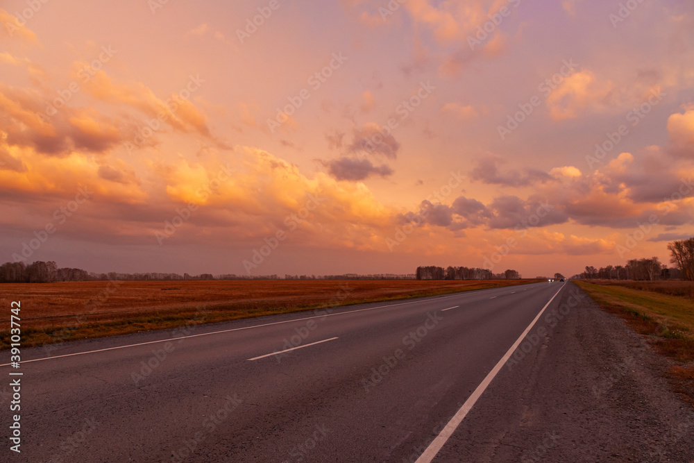 Road on the background of a picturesque sunset.