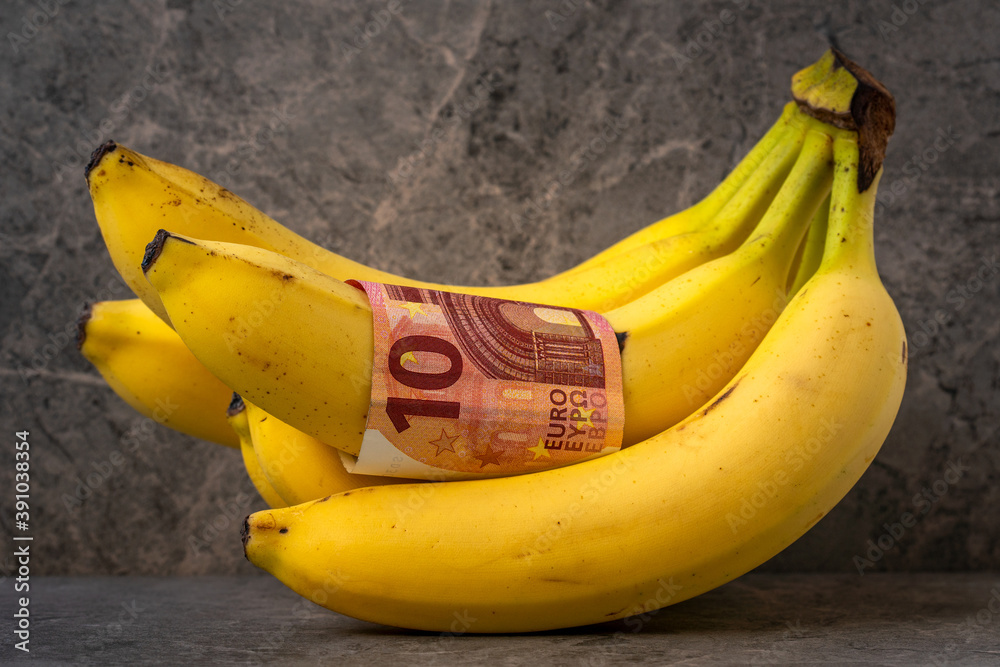 Bunch of ripe banana with ten euro banknote Bunch of ripe banana with ten euro banknote