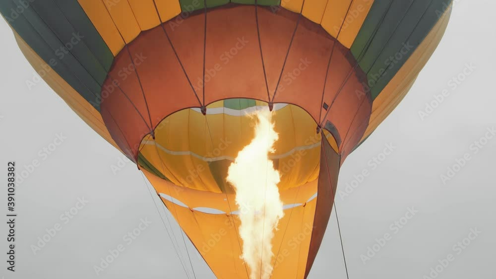 Travelers inflate the balloon with warm air and prepare to fly in a balloon above the clouds. Preparing for a balloon flight