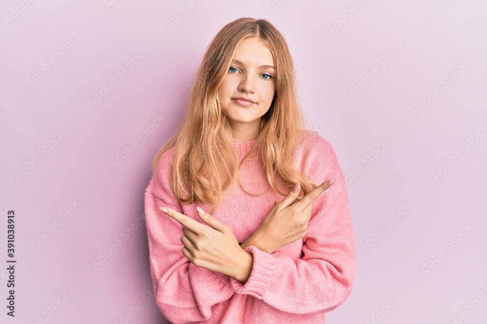 Fototapeta premium Beautiful young caucasian girl wearing casual clothes pointing to both sides with fingers, different direction disagree