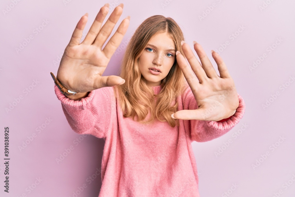 Beautiful young caucasian girl wearing casual clothes doing frame using hands palms and fingers, camera perspective Beautiful young caucasian girl wearing casual clothes doing frame using hands palms and fingers, camera perspective