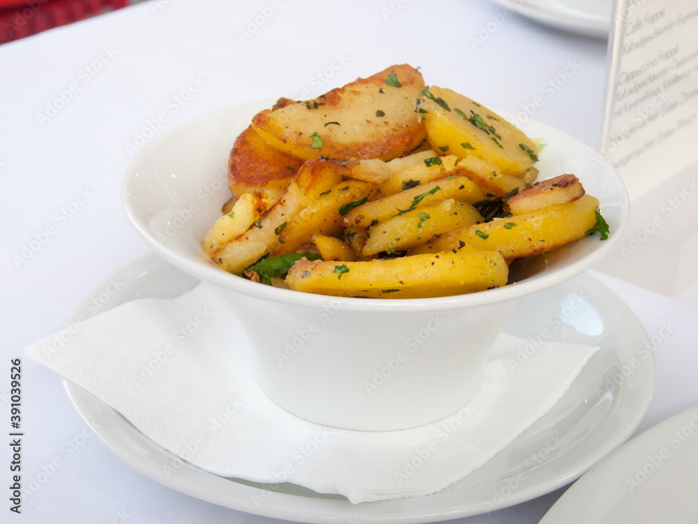 small porcelain bowl filled with fried potatoes small porcelain bowl filled with fried potatoes