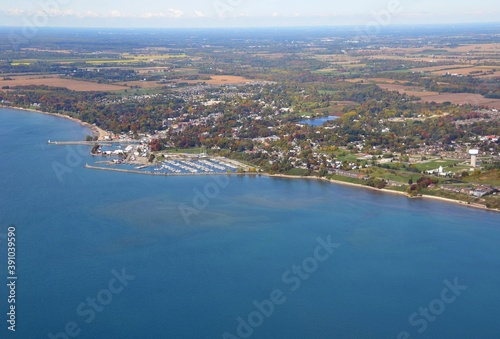 Aerial view from above Lake Erie towards the shoreline near the small town of Port Dover home of Friday the 13th biker meets, Autumn Season colors; Ontario Canada