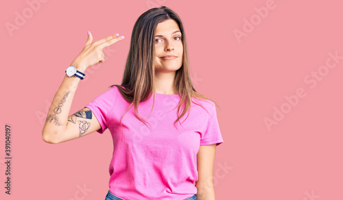Tablou pe pânză Beautiful caucasian woman wearing casual clothes shooting and killing oneself pointing hand and fingers to head like gun, suicide gesture