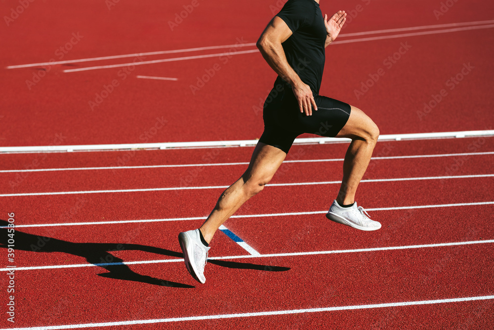 Fitness man running on the red running track. Copy space. Close Up. Lifestyle and sports Fitness man running on the red running track. Copy space. Close Up. Lifestyle and sports
