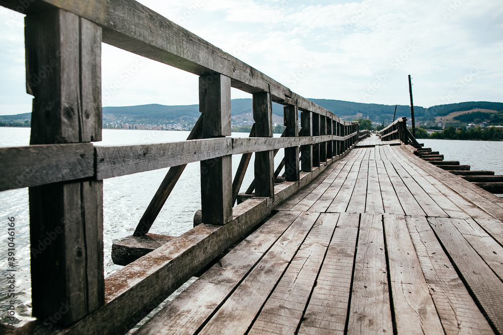 wooden bridge made of planks, old bridge over the river, long bridge over the pond. wooden bridge made of planks, old bridge over the river, long bridge over the pond.