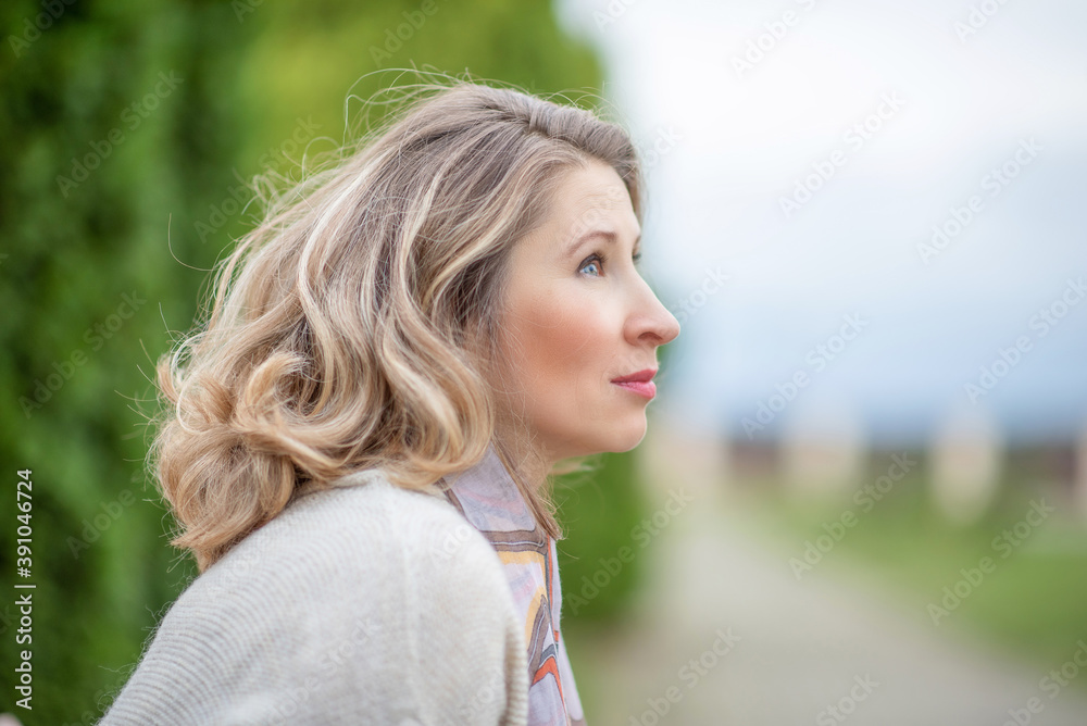 Portrait of a young beautiful blonde girl in the park close-up. Portrait of a young beautiful blonde girl in the park close-up.