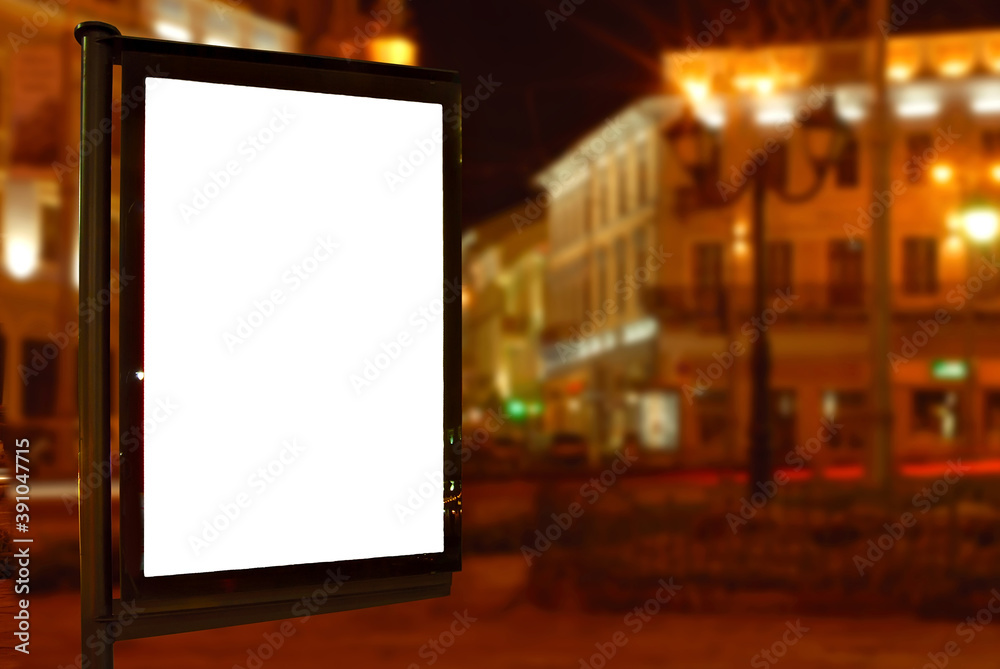 Blank signboard on the background of the night city. Mockup for design. Free space for advertising. Sharpness on the banner from the edge of the frame. Blank signboard on the background of the night city. Mockup for design. Free space for advertising. Sharpness on the banner from the edge of the frame.