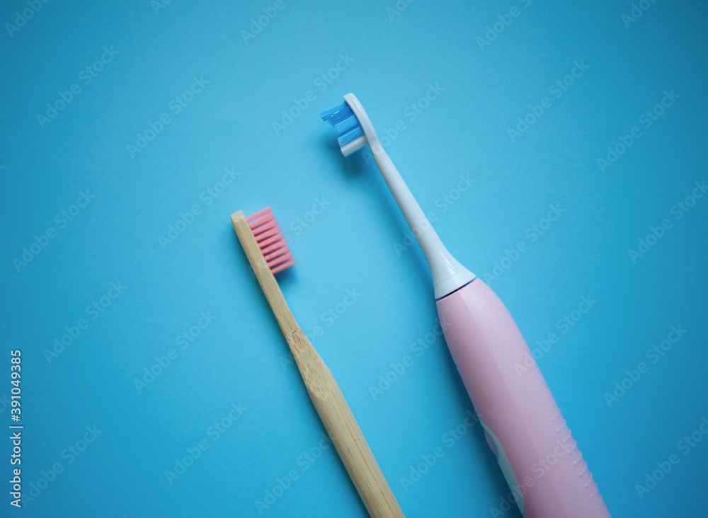 two ultrasonic electric toothbrushes on a blue background two ultrasonic electric toothbrushes on a blue background