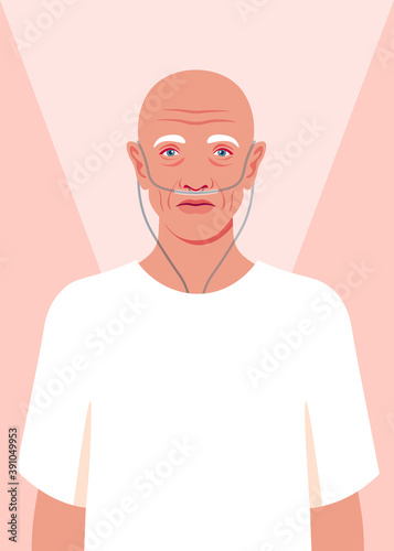 Bald senior man is standing in the hospital. Old сancer patient with a nasal breathing tube feeling lonely at hospice. Health care for the elderly people. Coronavirus and respiratory therapy.