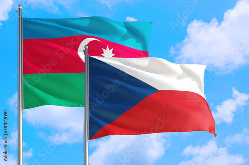 Czech Republic and Azerbaijan national flag waving in the windy deep blue sky. Diplomacy and international relations concept.