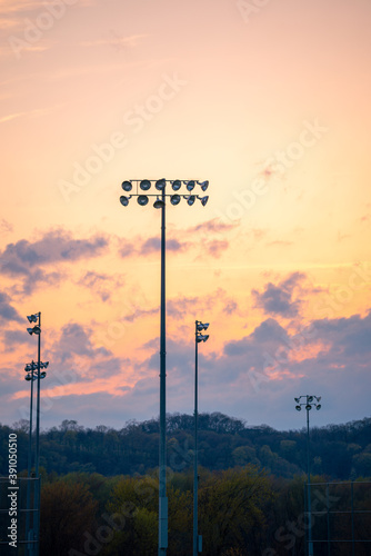 Stadium light lantern or spotlight while sunset or sunrise with mountain in behind.
