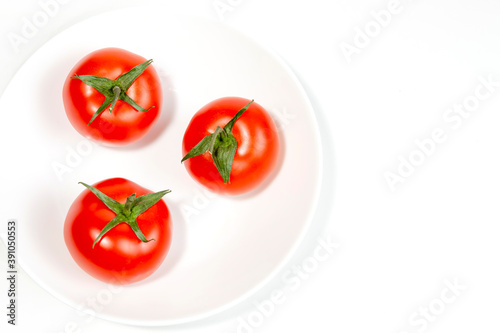 several red tomatoes on a branch isolated on white background © Вячеслав 