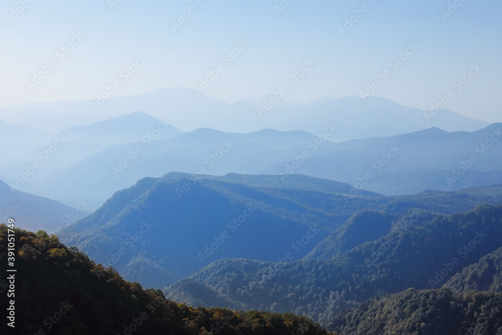 Range of mountains in the blue haze of an early autumn morning