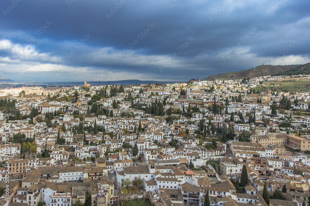 Aerial dramatic panoramic view of the old city in Granada, Spain, located at foot of Sierra Nevada Mountains. European cityscape.Beautiful white Spanish city.Albaicin Moorish medieval quarter.
