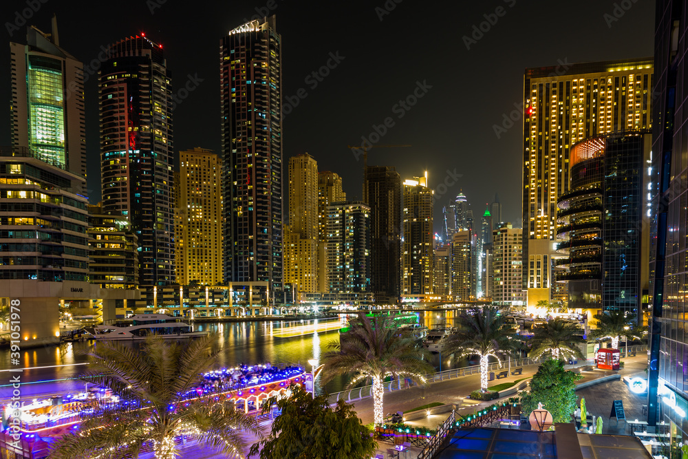 Fototapeta premium Dubai Marina at night, with all the lights from buildings and the boats making for a beautiful scene