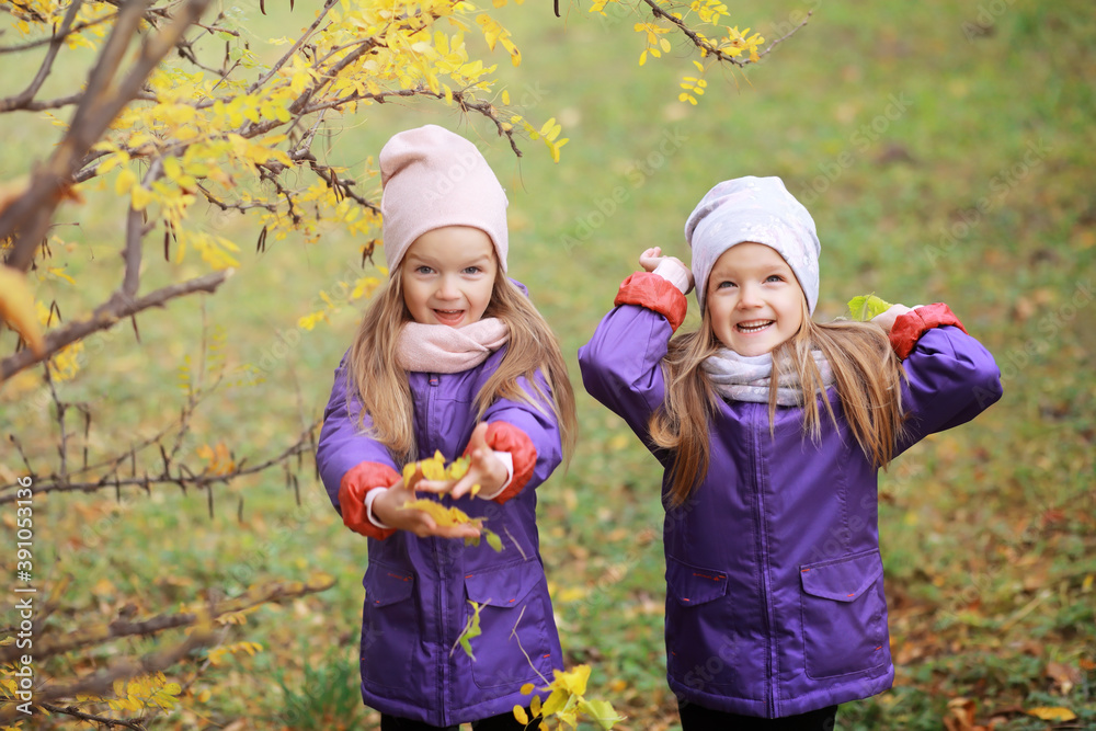 Young family on a walk in the autumn park on a sunny day. Happiness to be together. Young family on a walk in the autumn park on a sunny day. Happiness to be together.