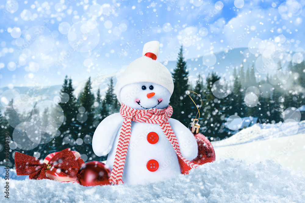 Obraz premium Cute toy snowman with Christmas balls in winter forest