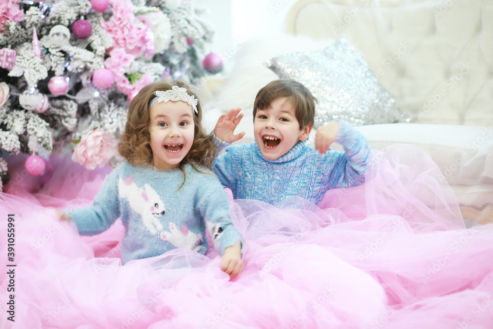 Family decorating beautiful live Christmas tree. Loving family with presents in room. Happy family on holidays. Family decorating beautiful live Christmas tree. Loving family with presents in room. Happy family on holidays.