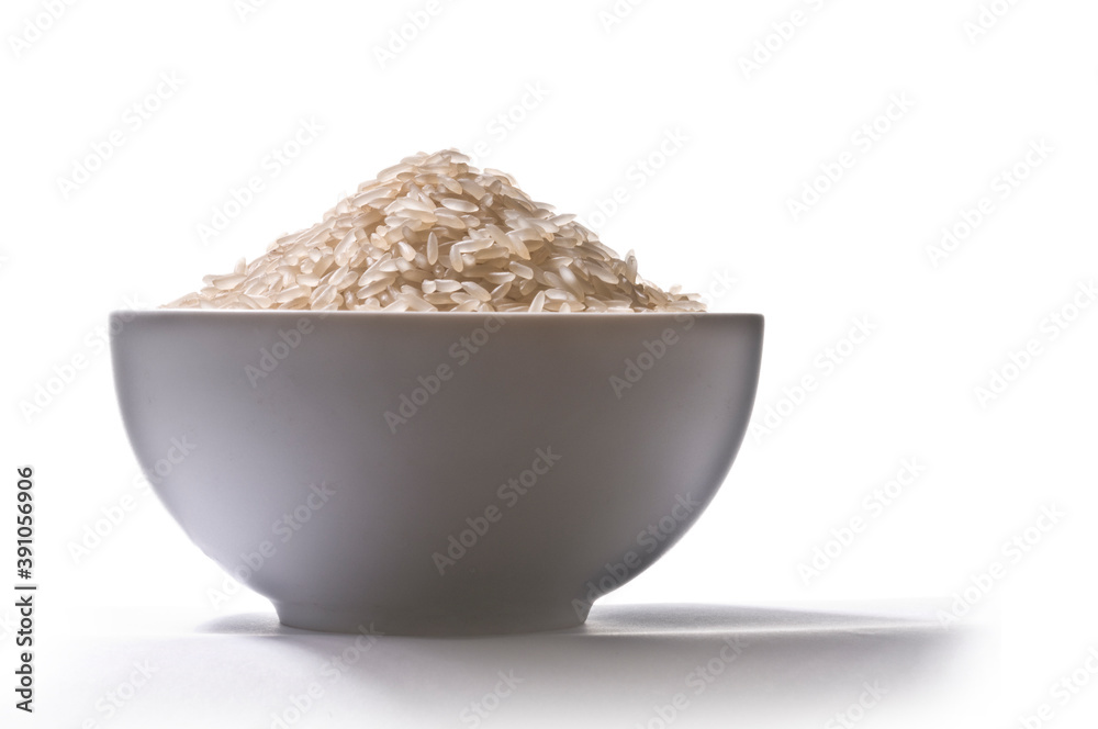 Cup filled with raw rice grains, lateral view, on white background and shadow
Cup filled with raw rice grains, lateral view, on white background and shadow