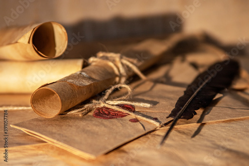 Bokeh. Part of an ancient paper scroll, close-up, illuminated by a sunbeam. The letter is sealed. Old map.