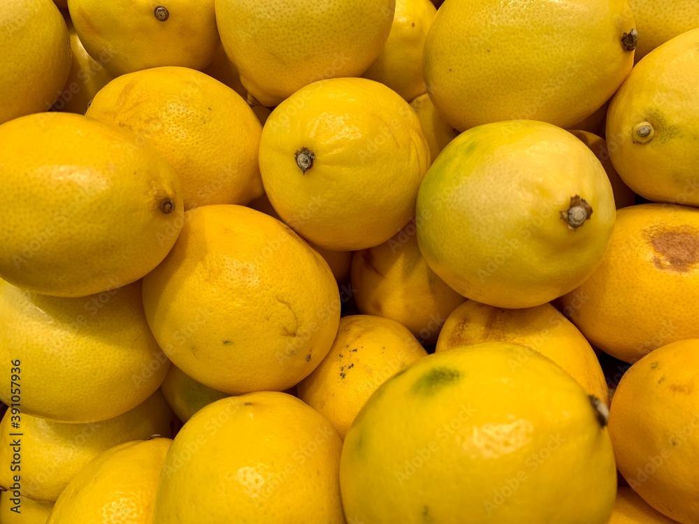 a lot of yellow lemons with small defects in market
