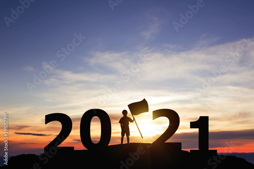 Silhouette freedom little boy standing on peaks with New year 2021. Education concept