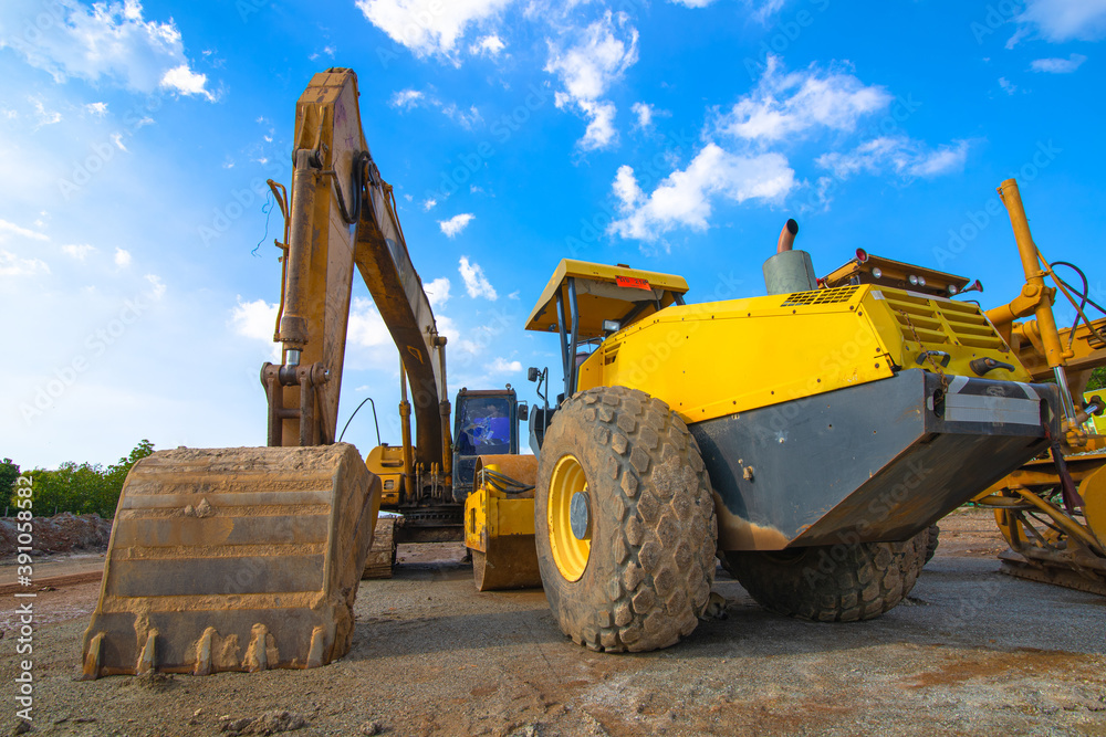 Backhoe, grader and road roller on the ground at site construction. Backhoe, grader and road roller on the ground at site construction.