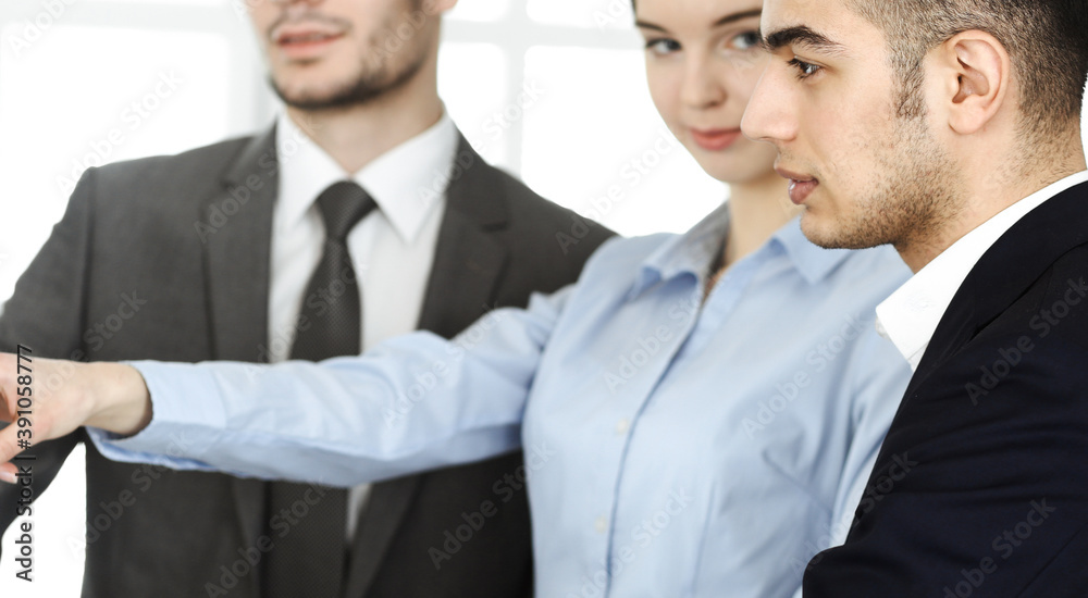 Group of business people discussing questions at meeting in office. Colleagues working with computer at workplace Group of business people discussing questions at meeting in office. Colleagues working with computer at workplace