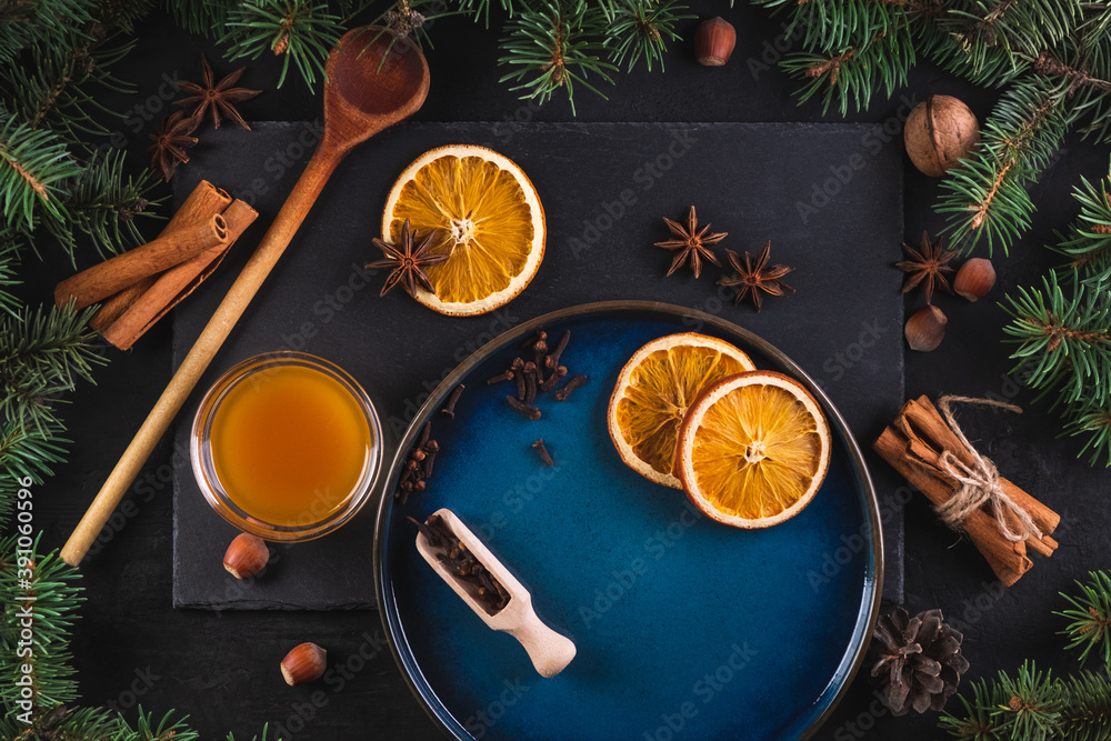 Top-down plan, festive food background. Christmas table decoration with branches of a Christmas tree and aromatic spices. Top-down plan, festive food background. Christmas table decoration with branches of a Christmas tree and aromatic spices.