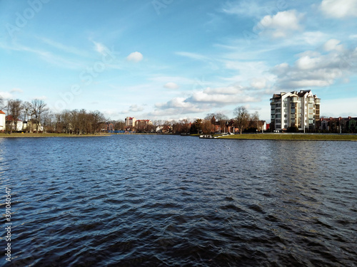 Modern luxurious multistory residential buildings on embankment of Upper Lake - artificial city pond, famous tourist attraction and popular leisure zone in Kaliningrad, Russia at sunny day photo