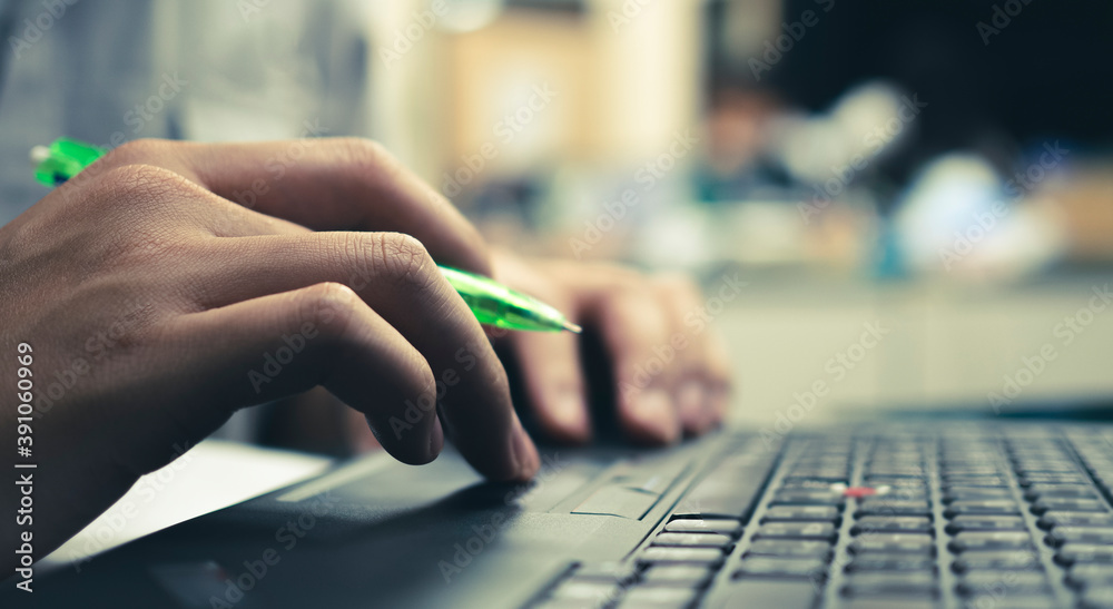 Fototapeta premium close up of business people pressing keyboard of notebook, working online and business online