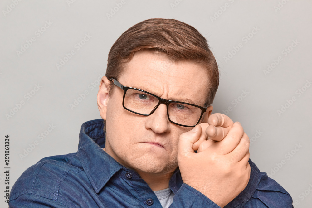 Portrait of concentrated man making gun gesture and pointing at you Portrait of concentrated man making gun gesture and pointing at you