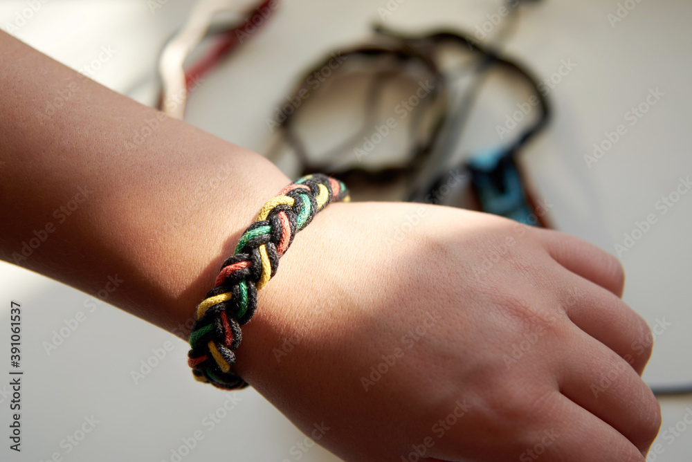 Bracelet made of fabric ropes on a woman's hand.