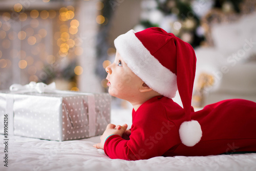 baby in santa claus hat with gifts