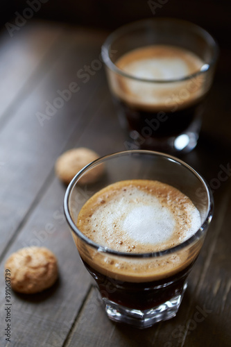 Two Glasses Of Coffee with Milk on dark wooden background.	