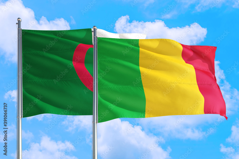 Obraz premium Mali and Algeria national flag waving in the windy deep blue sky. Diplomacy and international relations concept.