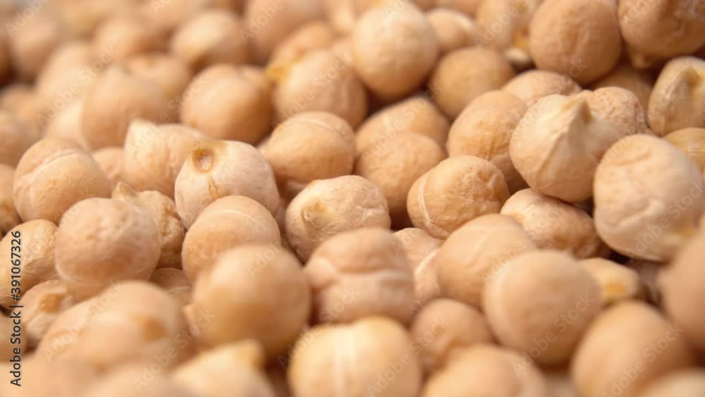 Heap of chickpeas close-up. Fresh uncooked raw food. Cicer arietinum. Rotation. Macro shot Heap of chickpeas close-up. Fresh uncooked raw food. Cicer arietinum. Rotation. Macro shot