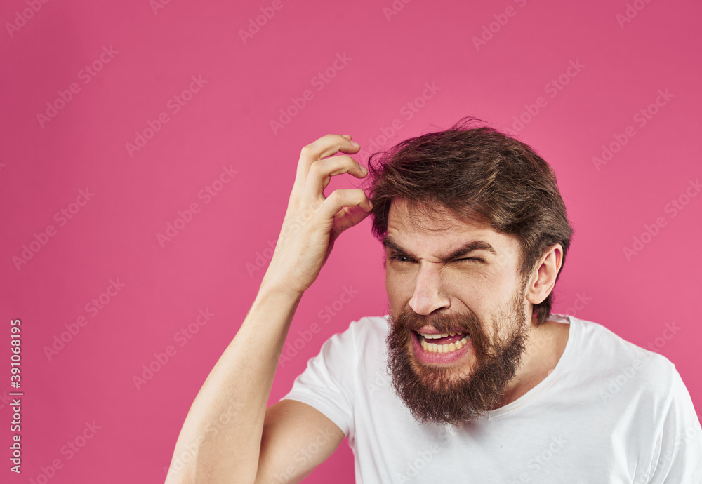 angry man with beard holds hands near face and stress irritability angry man with beard holds hands near face and stress irritability
