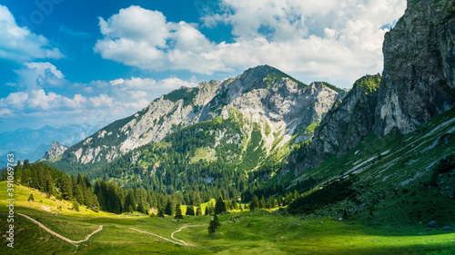 Germany, Allgaeu, Breitenberg, Impressive mountain view and green alpine nature landscapes of meadows and hiking trails on sunny day photo