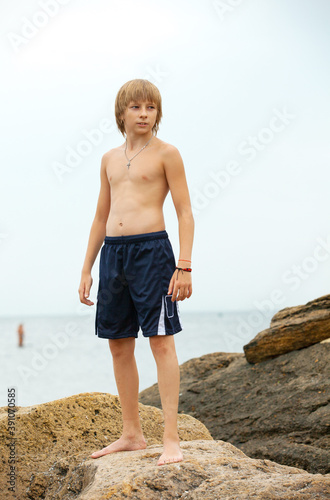 Boy practicing karate on the seashore