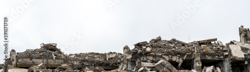 Panorama of the remains of a destroyed building, piles of concrete debris and construction debris. Background.