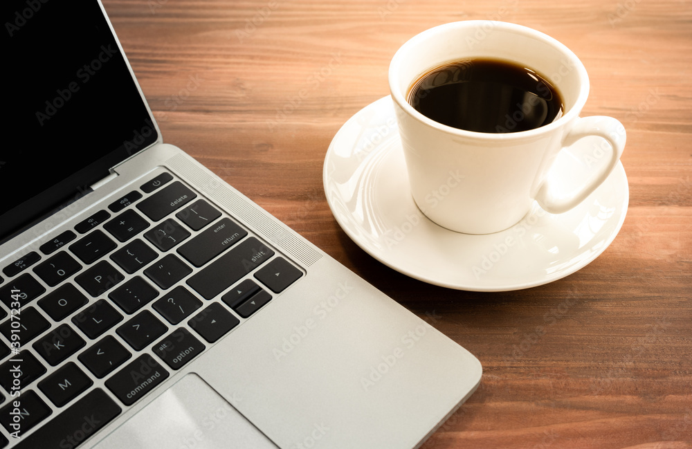 Laptop with cup of coffee on old wooden table. Laptop with cup of coffee on old wooden table.