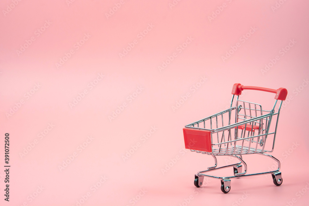 Shopping concept - Red shopping cart on pink background with copy space. Shopping concept - Red shopping cart on pink background with copy space.